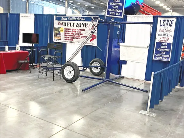 Lewis Cattle Oilers trade show booth with a display oiler and no-fly-zone signs